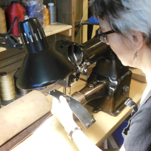 Sara of The Chicago School of Shoemaking working on a leather cuff.