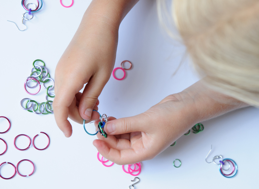 child's hands making chainmail linkt craft kits 