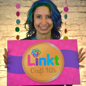 Rebeca Mojica holding Linkt Crafts Kit sign