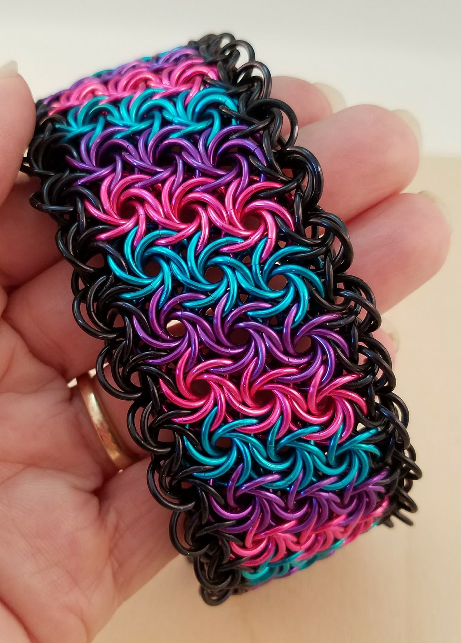 pink, purple, turquoise moorish rose cuff with black edging