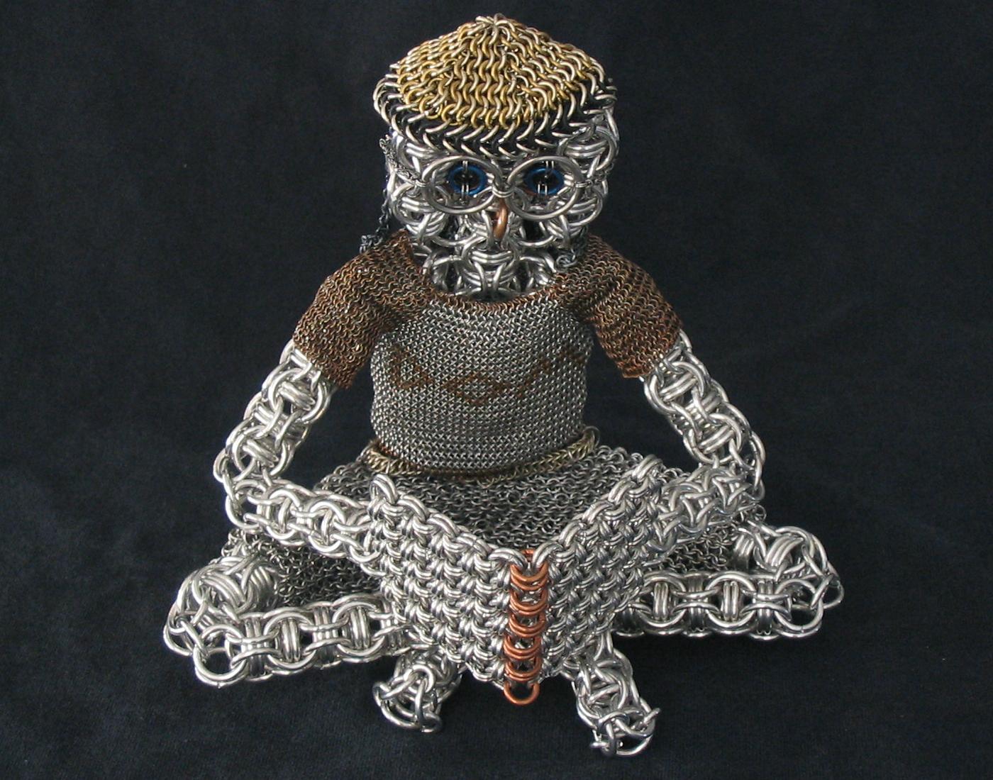 chainmaille sculpture man reading by Dave Austin