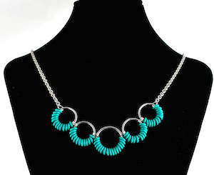 turquoise rubbermaille and aluminum simple coiled necklace on black neckform