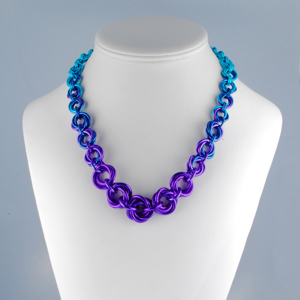 chainmail necklace in purple blue and turquoise on display form