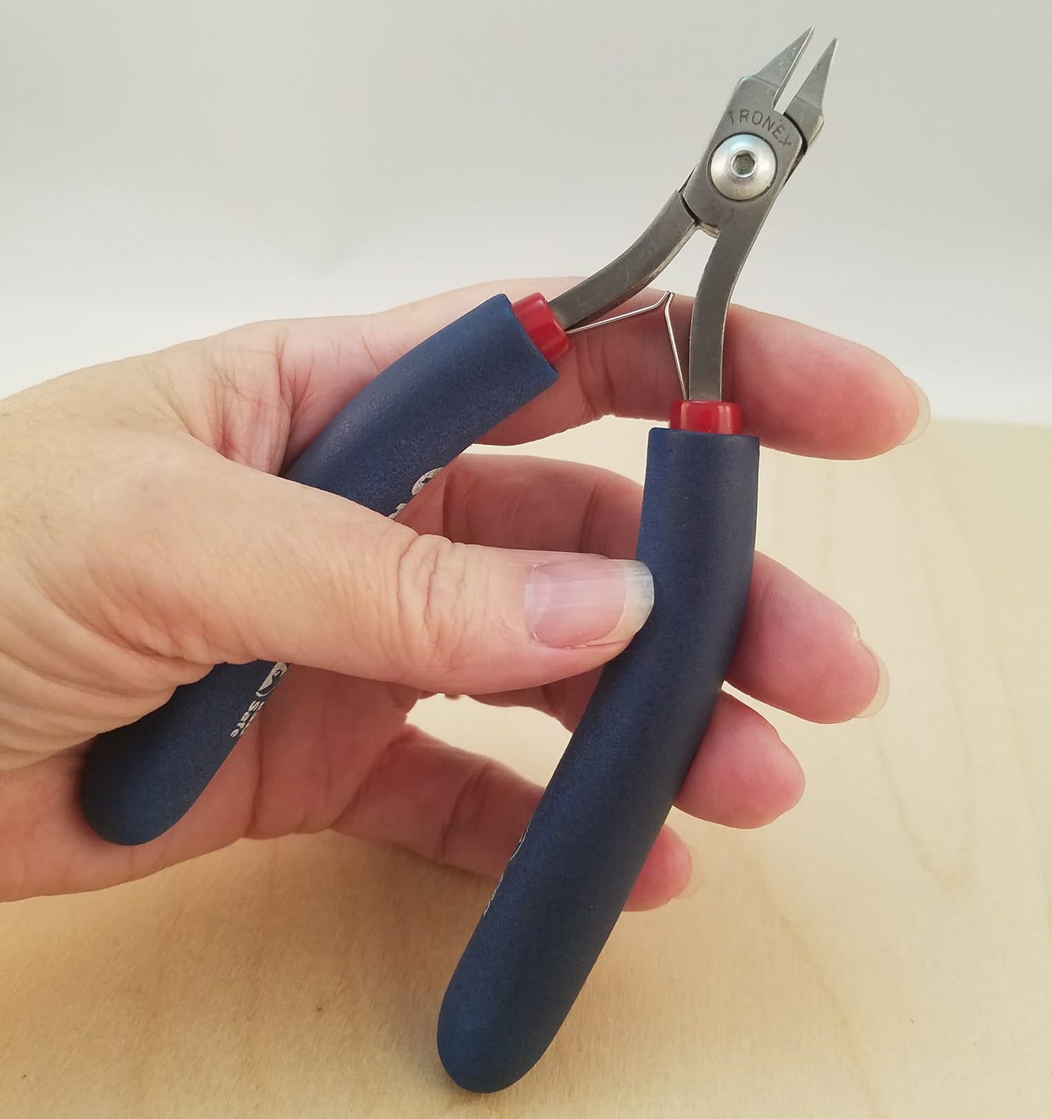 hand with tronex snub nose pliers