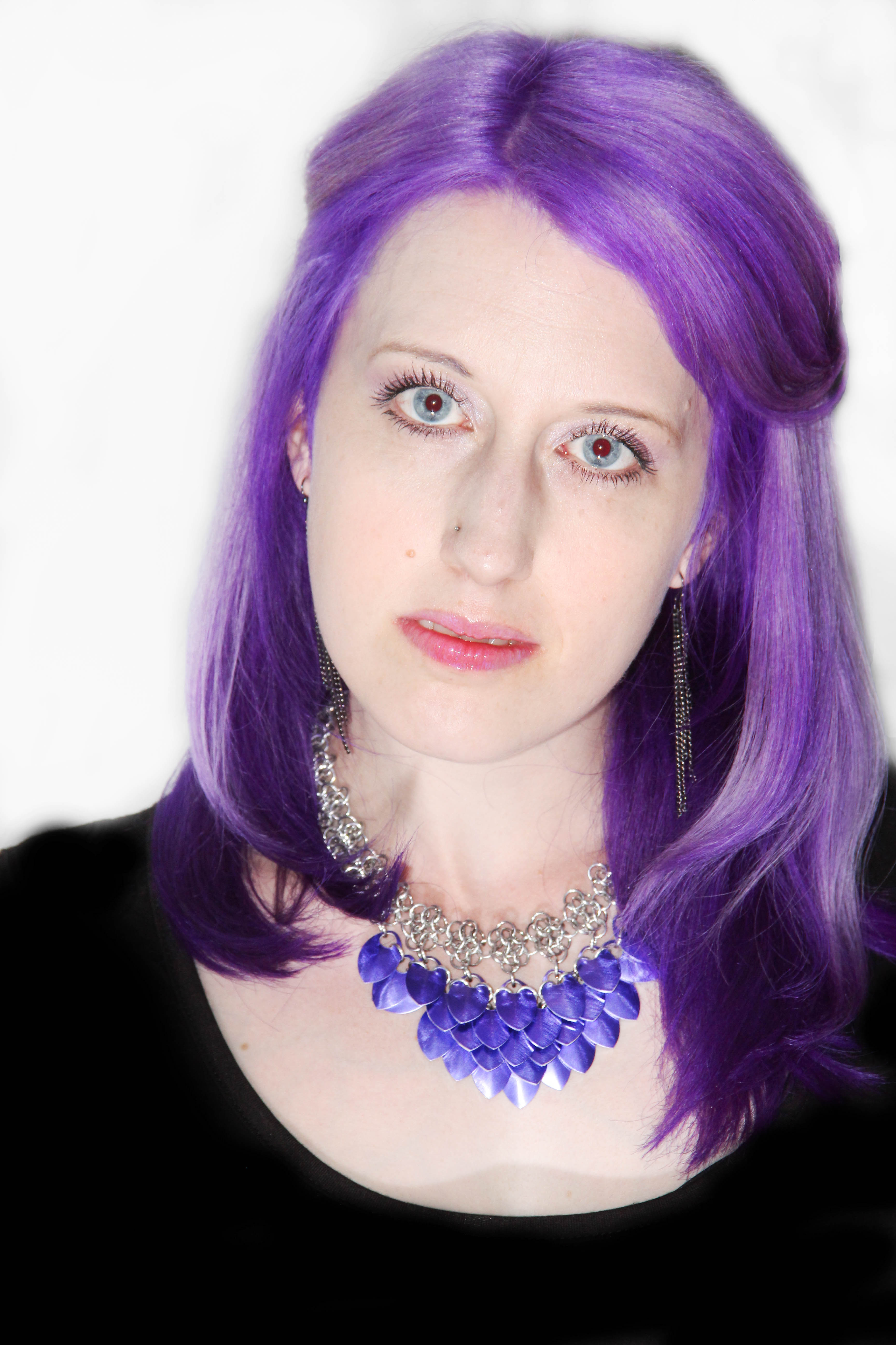 Woman with purple hair wearing purple and silver scalemaille necklace