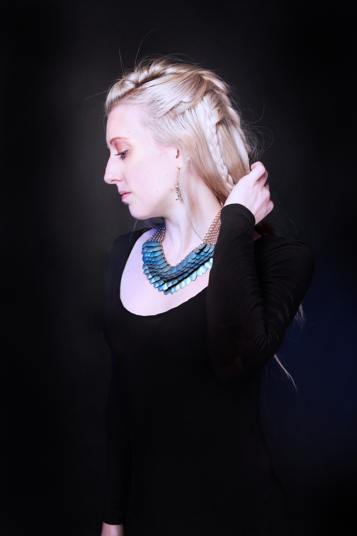 Scalemaille designer Sally of It Is Known wearing iridescent blue and green statement necklace
