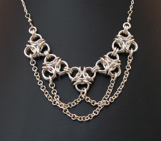 Aura2 chainmaille necklace in silver with draping chains on dark grey background