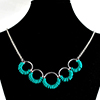 Coiled Rubber Scallop, KIT - Coiled Rubber Scallop Aluminum w/ Custom Rubber, simple chainmail necklace with small turquoise silicone rings on large jump rings on a black jewelry display bust